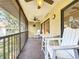 Cozy balcony with a table, chairs, and a ceiling fan offers serene outdoor living at 654 Bird Bay E Dr # 206, Venice, FL 34285