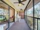 Balcony seating area with sliding glass doors, ceiling fans, and pleasant outdoor space at 654 Bird Bay E Dr # 206, Venice, FL 34285