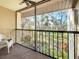 Relaxing view from a screened balcony with lush greenery and a tranquil pond at 654 Bird Bay E Dr # 206, Venice, FL 34285