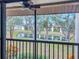 A tranquil view from the screened balcony overlooks a serene pond and lush greenery at 654 Bird Bay E Dr # 206, Venice, FL 34285