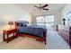 Cozy bedroom with a comfortable bed, ceiling fan, and sliding glass doors to a balcony at 654 Bird Bay E Dr # 206, Venice, FL 34285