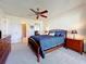 Carpeted bedroom with ceiling fan, furnishings, and ensuite bathroom at 654 Bird Bay E Dr # 206, Venice, FL 34285