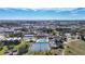 An aerial image of the community with a pool, clubhouse and tennis courts with a skyline view at 654 Bird Bay E Dr # 206, Venice, FL 34285