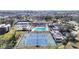 An aerial view of the community featuring tennis courts and the sparkling pool at 654 Bird Bay E Dr # 206, Venice, FL 34285