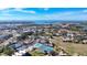 An aerial shot showing community with pool, tennis courts, clubhouse with ocean views at 654 Bird Bay E Dr # 206, Venice, FL 34285