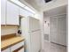Efficient kitchen featuring a refrigerator, wood counters, and tiled floor at 654 Bird Bay E Dr # 206, Venice, FL 34285