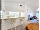 The kitchen features a breakfast bar, refrigerator, and dining area at 654 Bird Bay E Dr # 206, Venice, FL 34285