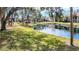 Lush landscaping surrounds the community pond creating a peaceful setting at 654 Bird Bay E Dr # 206, Venice, FL 34285