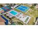 Aerial of pool, tennis courts, and other recreational facilities, surrounded by lush landscaping at 654 Bird Bay E Dr # 206, Venice, FL 34285
