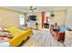 Bright bedroom with lots of natural light, ceiling fan, wood-look vinyl floors and cheerful yellow bedspread at 8307 Glover Ave, North Port, FL 34291