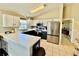 Modern kitchen with stainless steel appliances, white cabinets, and a breakfast bar at 8307 Glover Ave, North Port, FL 34291