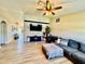 Open living room with a feature wall, a large screen TV and a comfortable sectional sofa at 8307 Glover Ave, North Port, FL 34291