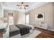 Comfortable bedroom with neutral décor and tray ceiling with natural light at 1206 Tuscany Blvd, Venice, FL 34292