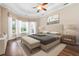 Bedroom suite featuring neutral colors and tray ceilings with a seating area at 1206 Tuscany Blvd, Venice, FL 34292