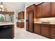 Spacious kitchen with custom cherry wood cabinetry and modern, stainless steel appliances at 1206 Tuscany Blvd, Venice, FL 34292