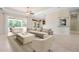 Spacious living room with sliding glass doors, recessed lighting, and comfortable seating at 1206 Tuscany Blvd, Venice, FL 34292