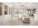 Inviting living room with large windows, built-in shelving, and a ceiling fan at 1206 Tuscany Blvd, Venice, FL 34292