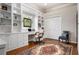 Bright home office with custom built-in shelving, desk, and hardwood floors at 1206 Tuscany Blvd, Venice, FL 34292