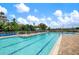 Community pool featuring lap lanes, ample seating, and tropical landscaping at 1206 Tuscany Blvd, Venice, FL 34292