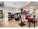 Well-stocked pro shop with clothing racks, golf bags, and accessories for sale at 1206 Tuscany Blvd, Venice, FL 34292