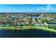 Wide aerial view of a waterfront community with a clubhouse, swimming pools and winding waterways at 13364 Dimarco St, Venice, FL 34293