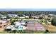 Aerial view of the community recreation area featuring a pool, tennis courts, and surrounding greenery at 1815 Killdeer Ct, Venice, FL 34293