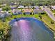 Aerial view of home on the water showing pool, screened patio, and lush backyard at 1815 Killdeer Ct, Venice, FL 34293