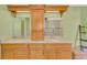 Double vanity with granite countertops and natural wood cabinetry at 1815 Killdeer Ct, Venice, FL 34293