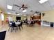 Spacious clubhouse featuring tables, chairs, ceiling fans, and a kitchenette for community gatherings at 1815 Killdeer Ct, Venice, FL 34293