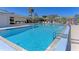 Community pool featuring crystal clear water, lounge chairs, tables, and shaded areas for relaxation at 1815 Killdeer Ct, Venice, FL 34293