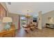 Well lit formal dining room with a decorative chandelier and neutral colored walls at 1815 Killdeer Ct, Venice, FL 34293