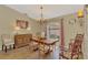 Traditional dining room with wood furniture, decorative lighting, and a large window for natural light at 1815 Killdeer Ct, Venice, FL 34293