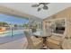 Covered lanai with seating area overlooking the screened pool and lake at 1815 Killdeer Ct, Venice, FL 34293