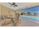 Enjoy serene lake views from this covered lanai with comfortable seating at 1815 Killdeer Ct, Venice, FL 34293