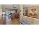 The living room flows into the dining area with views of the water and outdoor seating at 1815 Killdeer Ct, Venice, FL 34293