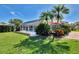 Relaxing backyard with screened pool, tropical plants, and an outdoor lounge area at 1815 Killdeer Ct, Venice, FL 34293