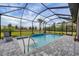 Screened-in pool featuring a waterfall feature, tiled flooring, and seating area at 19807 Bridgetown Loop, Venice, FL 34293
