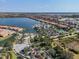 Aerial view highlighting community amenities with pool, tennis courts, townhouses and beautiful landscaping and a lake view at 232 Teramo Way, Nokomis, FL 34275