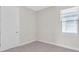 This bedroom offers plush carpet, a window, and a white door at 232 Teramo Way, Nokomis, FL 34275