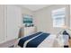Bright bedroom featuring a comfortable bed, stylish dresser, and window with natural light at 232 Teramo Way, Nokomis, FL 34275