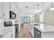 Modern kitchen featuring stainless appliances and sink, subway tile backsplash and white cabinetry at 232 Teramo Way, Nokomis, FL 34275