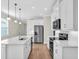 Modern kitchen features stainless steel appliances, a large island, and plenty of cabinet space for storage at 232 Teramo Way, Nokomis, FL 34275