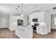 Bright, open kitchen features white cabinets, stainless appliances, and an island perfect for entertaining at 232 Teramo Way, Nokomis, FL 34275