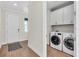 Convenient laundry room with a washer, dryer, and cabinetry for efficient storage and organization at 232 Teramo Way, Nokomis, FL 34275