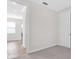 An empty room featuring neutral walls, carpeted flooring, and natural light, ready for personalization at 232 Teramo Way, Nokomis, FL 34275
