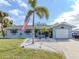 Charming single-story home with a well-manicured lawn and an American flag, showcasing curb appeal at 4911 Pompano Rd, Venice, FL 34293