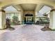 Inviting clubhouse entrance featuring a brick drive and elegant landscaping at 560 Fallbrook Dr, Venice, FL 34292