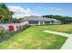 Beautiful clubhouse exterior featuring lush landscaping and a pristine lawn at 560 Fallbrook Dr, Venice, FL 34292
