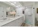 Clean bathroom featuring double sinks and glass shower at 5800 Sabal Trace Dr # 501, North Port, FL 34287