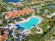 Aerial view of the community pool, clubhouse, and surrounding landscaping at 13864 Posada St, Venice, FL 34293